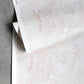 A pink and white patterned Pecosa Wallpaper Light Peach sheet with a resist dye technique