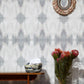 A vase of flowers on a table in front of Ripple Wallpaper Pearl
