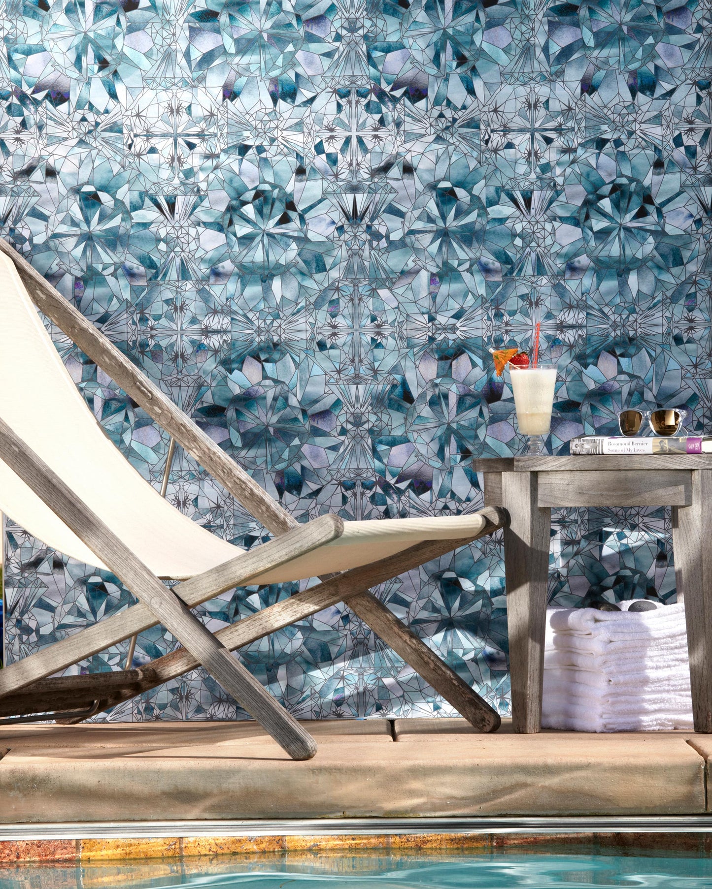 A Solitaire Wallpaper Pool next to a swimming pool, surrounded by the kaleidoscopic effect of shimmering water