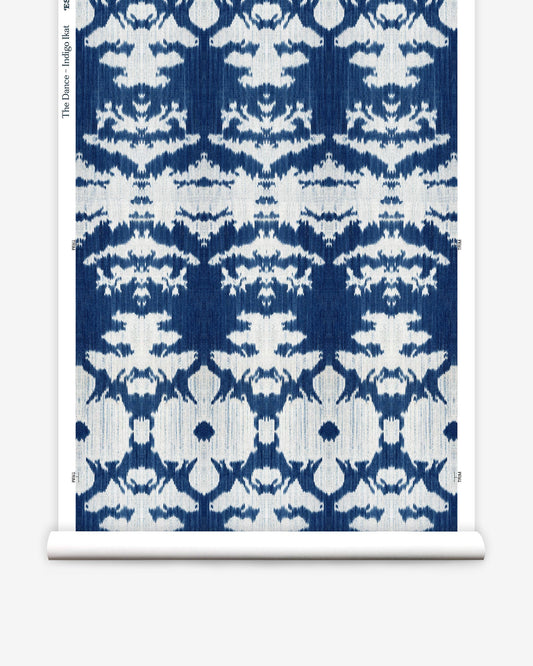 A blue and white pattern on a roll of The Dance Wallpaper Indigo Ikat paper from the Lora Collection