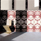 A room with a chair and a The Dance Wallpaper Morinda Ikat wall