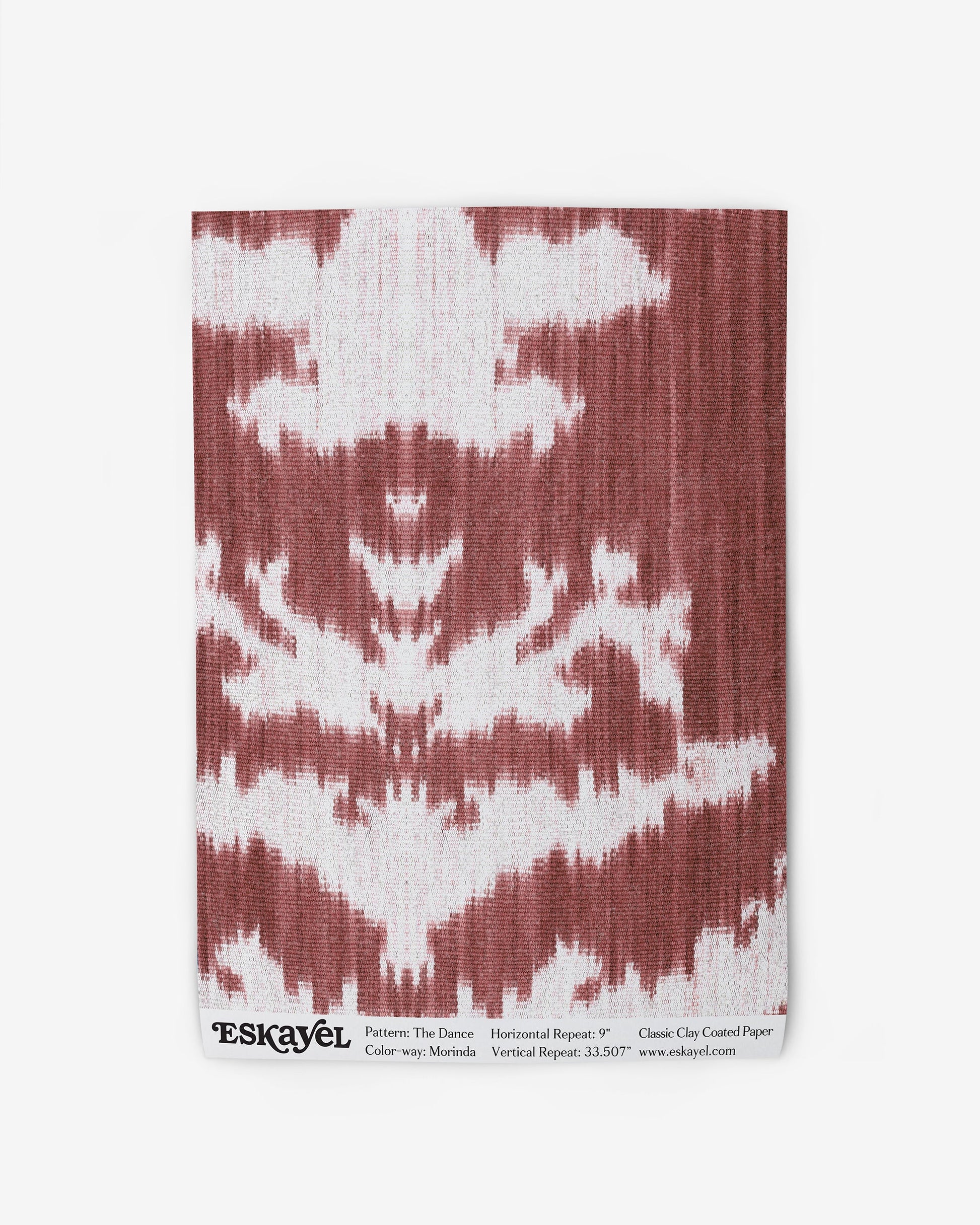 A red and white The Dance Wallpaper Morinda Ikat print on wallpaper