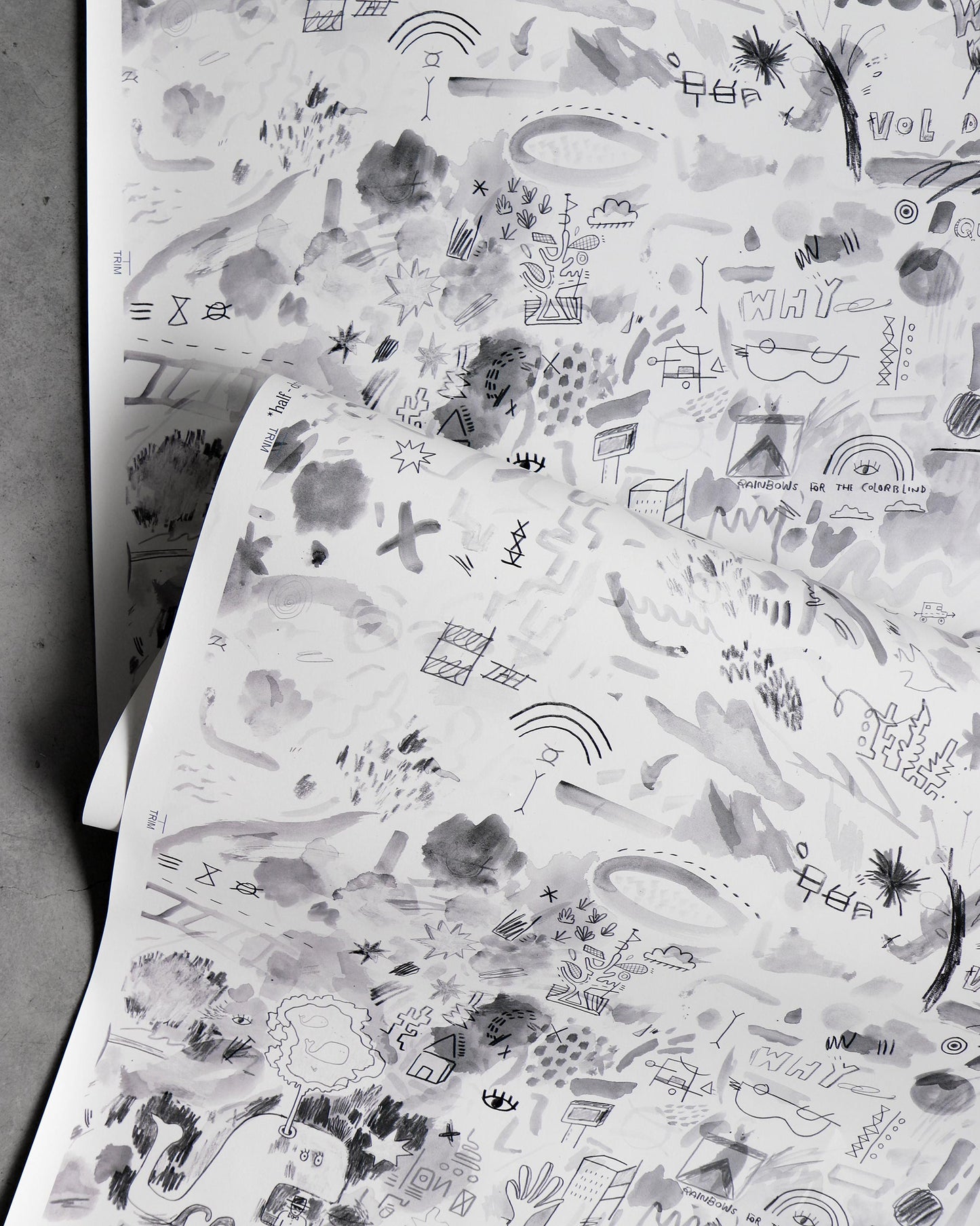 A piece of luxury fabric with Vol de Nuit Wallpaper||Noire drawings on it.
