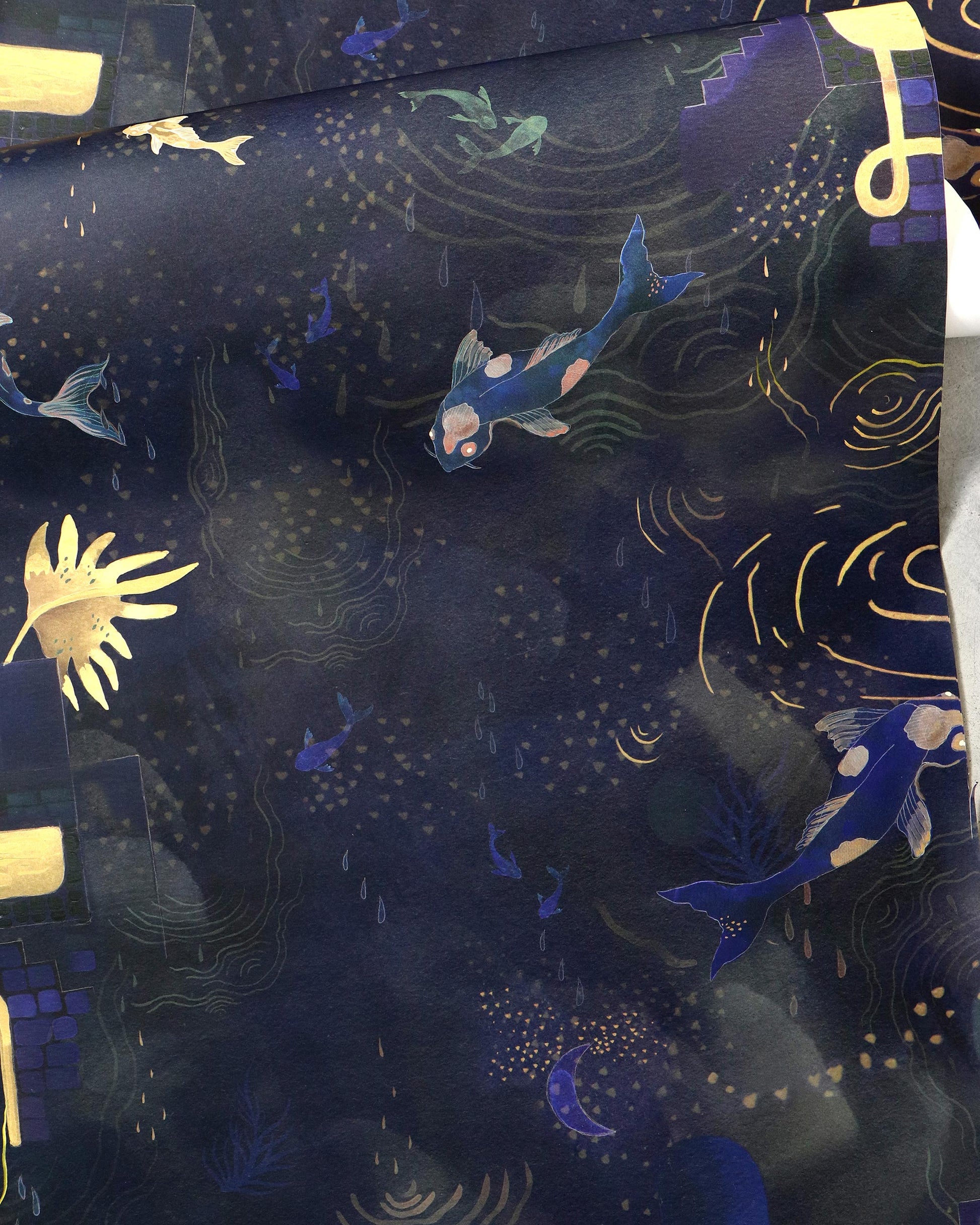 A blue and gold fabric with Water Signs Wallpaper Indigo on it