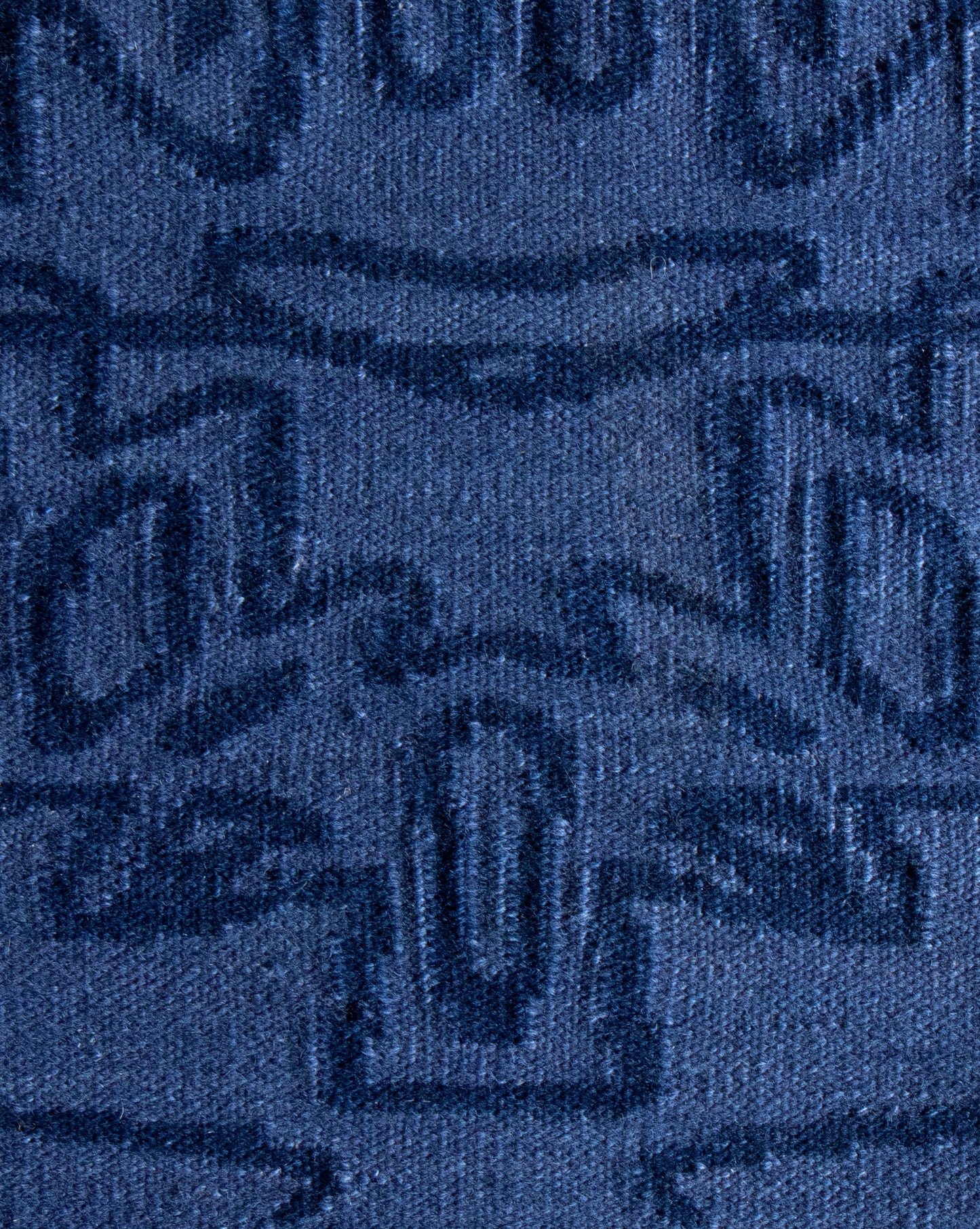 A close up of a blue fabric with an Akimbo 5 Flatweave Rug Indigo Inverse design on it