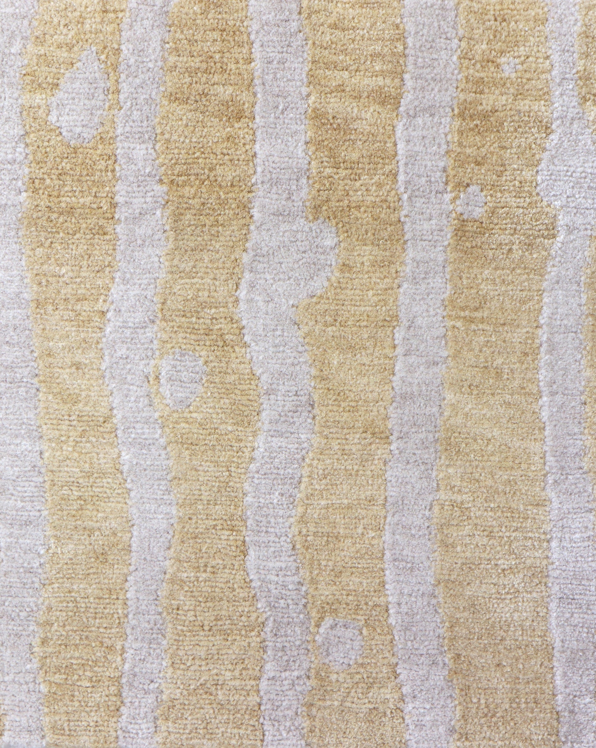 A beige and white Drippy Stripe Hand Knotted Rug Sage with bold contrasting colors of stripes on it
