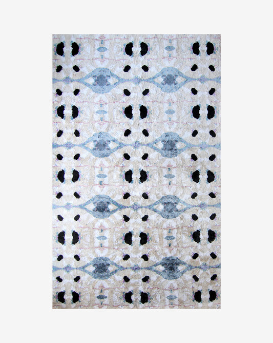 A Galileo Glass Hand Knotted Rug Slate with black and white dots on it