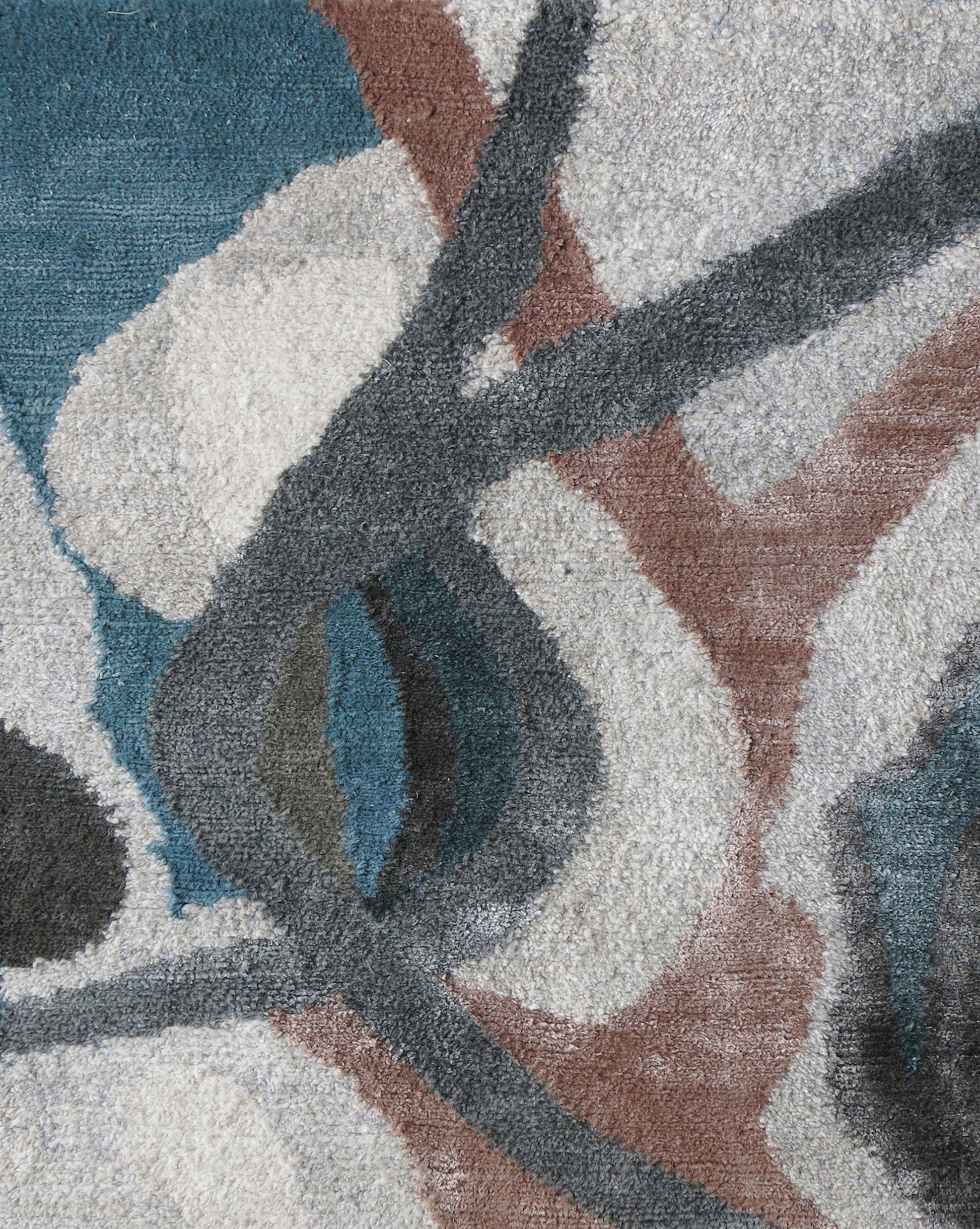 A custom handmade Kalypto Hand Knotted Rug Umber with a blue, gray, and brown abstract design from the Presidio Collection