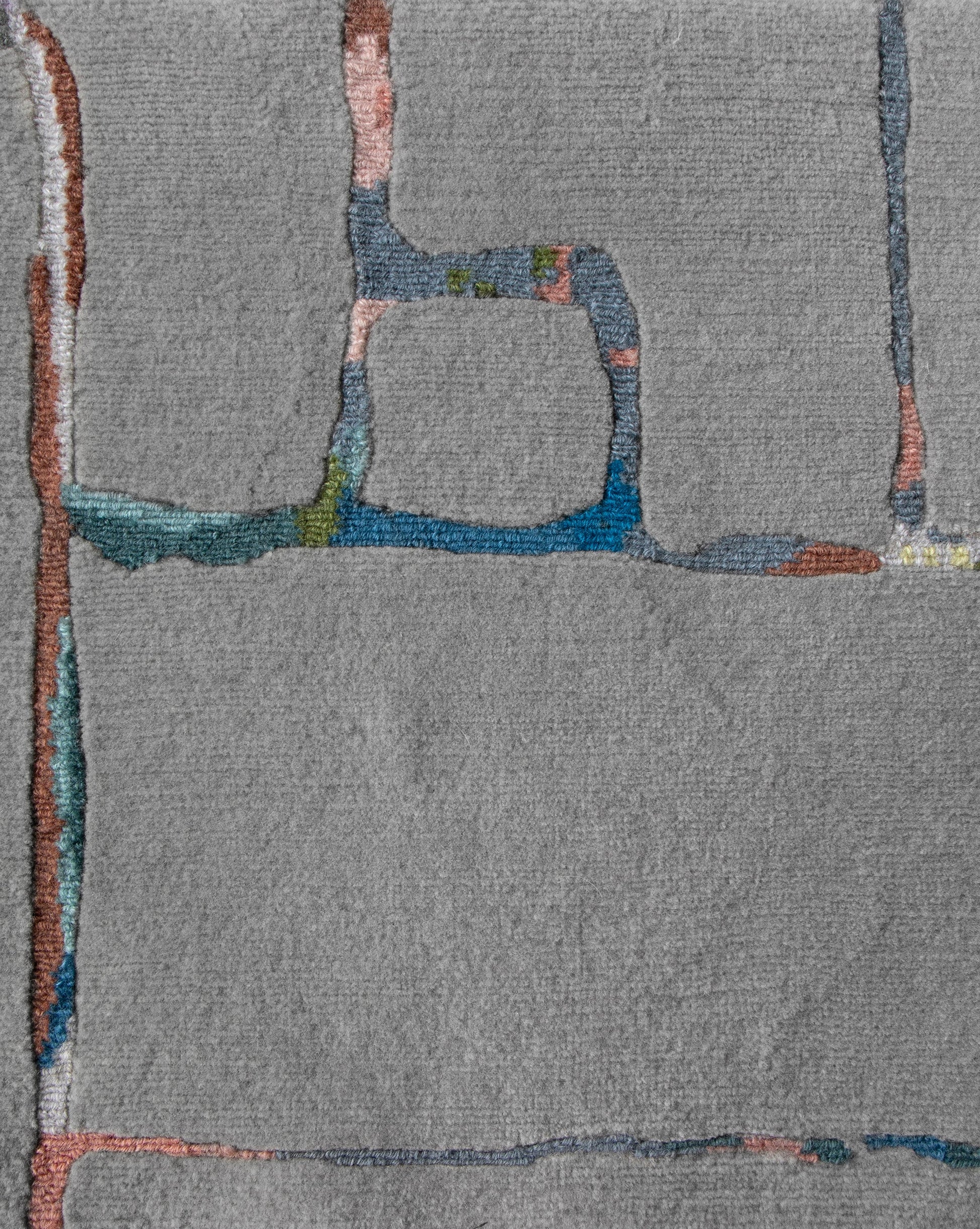 An abstract painting on a gray background with a Portico Hand Knotted Rug Greyscale Multi colorway