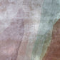 A close up of a pink, green, and brown fabric from the Progressions Hand Knotted Rug in the Corinth colorway.