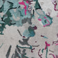 A close up image of a Bosky Toile Hand Knotted Rug with pink, blue, and green flowers in the Spectra colorway